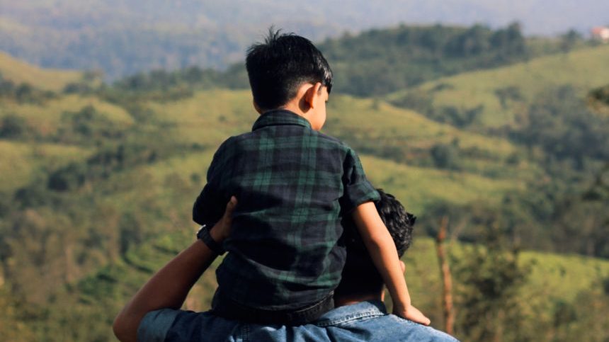 father and son enjoy scenic nature view